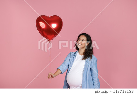 Happy young expecting woman celebrating Valentines Day Happy young expecting woman celebrating Valentines Day 112718155