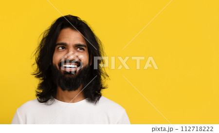 Positive millennial hindu guy looking at blank space Positive millennial hindu guy looking at blank space 112718222
