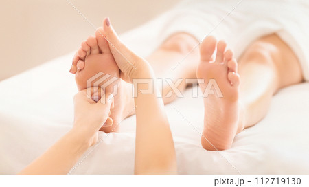 Foot massage. Woman relaxing at spa salon Foot massage. Woman relaxing at spa salon 112719130