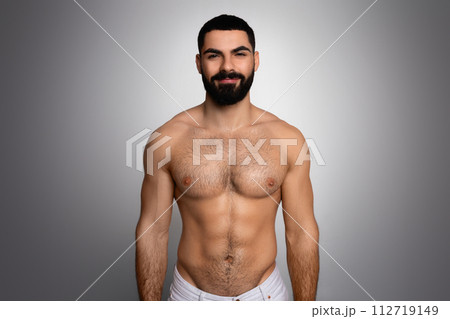 Studio shot of handsome athletic man posing after shower Studio shot of handsome athletic man posing after shower 112719149