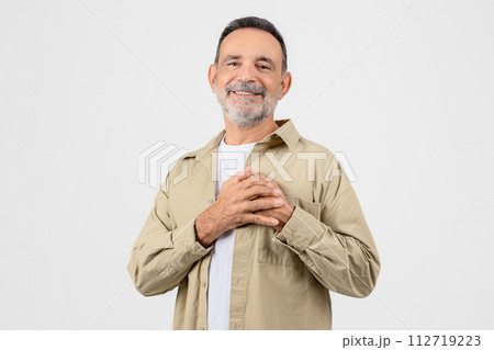 Gratitude Concept. Thankful Elderly Man Keeping Both Palms On Chest Gratitude Concept. Thankful Elderly Man Keeping Both Palms On Chest 112719223