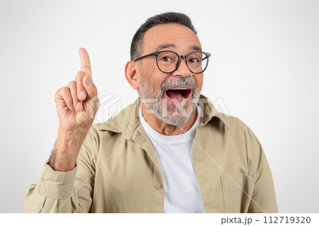 Idea Concept. Excited Senior Gentleman Pointing Finger Up And Looking At Camera Idea Concept. Excited Senior Gentleman Pointing Finger Up And Looking At Camera 112719320