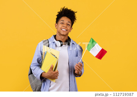 Joyful black student guy with Italian flag, ready for study abroad Joyful black student guy with Italian flag, ready for study abroad 112719387