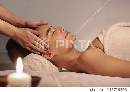 Spa treatment. Young woman enjoying face massage 112719508