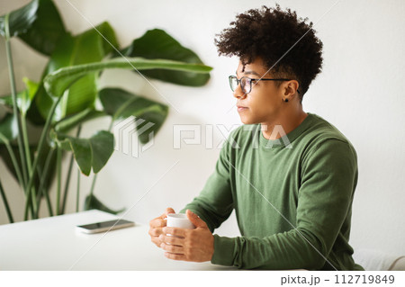 Cool black guy relaxing at cafe, drinking coffee Cool black guy relaxing at cafe, drinking coffee 112719849