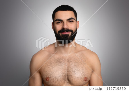 Studio shot of handsome bearded arab man posing shirtless Studio shot of handsome bearded arab man posing shirtless 112719850