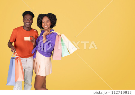 An exuberant young man in an orange shirt and a delighted young woman An exuberant young man in an orange shirt and a delighted young woman 112719913