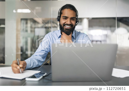 Smiling bearded young guy employee have online conference 112720651