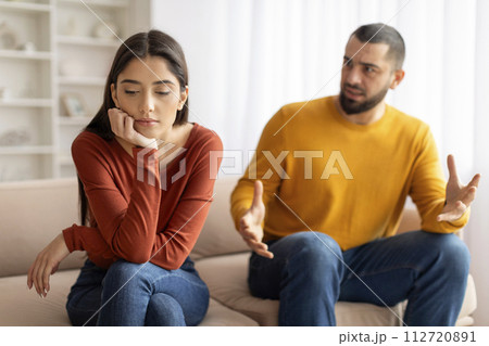 Domestic Conflicts. Young Married Couple Quarrelling In Living Room At Home Domestic Conflicts. Young Married Couple Quarrelling In Living Room At Home 112720891