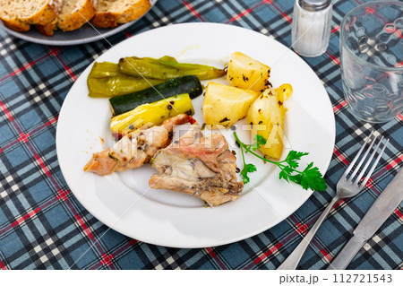 Roasted rabbit served with vegetable garnish 112721543