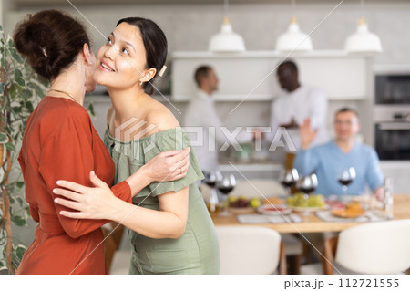 Two women greet each other when meeting 112721555