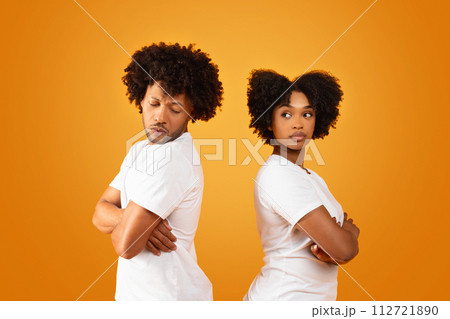 Unhappy african american man and woman standing back to back Unhappy african american man and woman standing back to back 112721890
