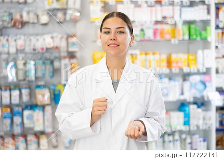 At pharmacy, apothecary waiting for customers and invites with gesture go to department of cosmetics 112722131