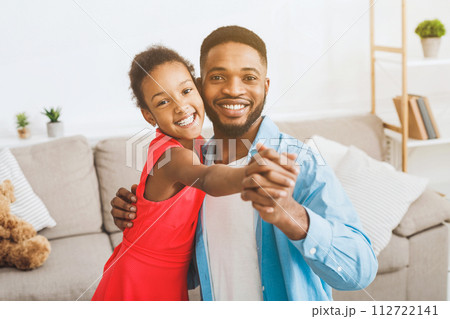 Handsome father and cute daughter dancing at home Handsome father and cute daughter dancing at home 112722141