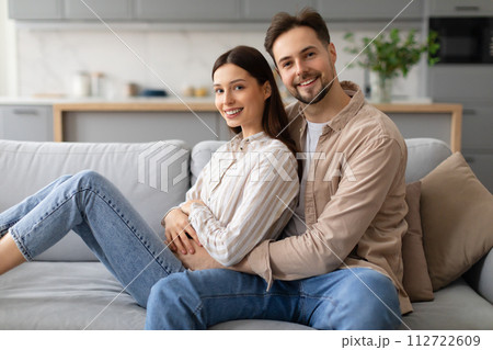 Happy couple relaxing together on cozy sofa at home 112722609