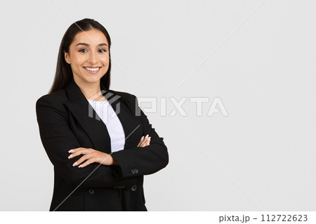 Confident professional woman in black suit smiling Confident professional woman in black suit smiling 112722623