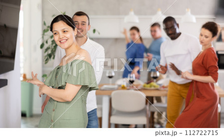 Happy middle-aged men and women doing quick dance in pairs Happy middle-aged men and women doing quick dance in pairs 112722715