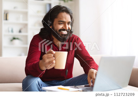 Positive eastern man manager have online morning briefing with team Positive eastern man manager have online morning briefing with team 112723209