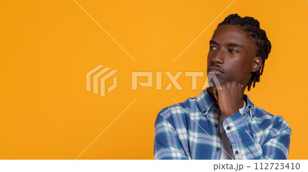 Pensive African American Guy Looking Aside At Copy Space And Touching Chin 112723410