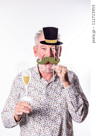 Playful Senior Man with Party Hat and Fake Mustache Props 112723955