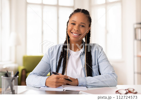 Confident black lady student smiling at camera, ready for e-learning Confident black lady student smiling at camera, ready for e-learning 112724573