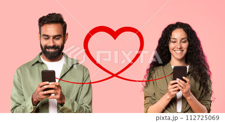 A man with a beard in an olive shirt smiles at his smartphone, and a woman with curly hair 112725069