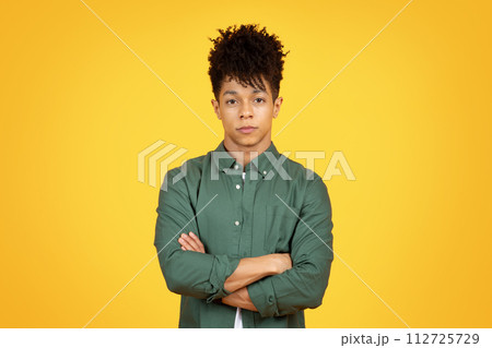 Confident handsome african american man wearing green shirt Confident handsome african american man wearing green shirt 112725729