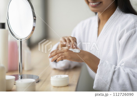 Cropped of indian woman enjoying her morning body care routine Cropped of indian woman enjoying her morning body care routine 112726090
