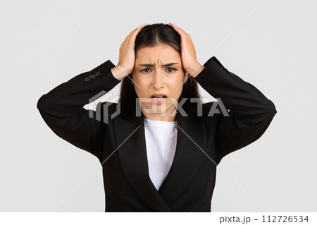 Stressed businesswoman with hands on head, showing frustration Stressed businesswoman with hands on head, showing frustration 112726534