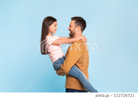 Happy Father Carrying His Little Daughter In Hug, Studio Happy Father Carrying His Little Daughter In Hug, Studio 112726721