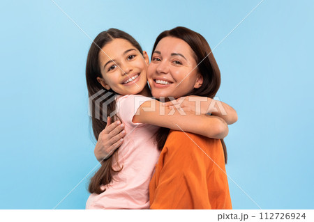 Portrait Of Smiling Young Mother And Cute Preteen Daughter Embracing 112726924
