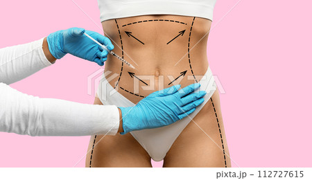 Unrecognizable woman in underwear getting injection in belly 112727615