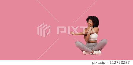 Smiling black woman doing arm stretch, panorama with free space 112728287