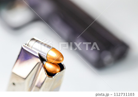 bullet 9mm FMJ (Full Metal Jacketed ) Shell Shock Technologies (NAS3) in magazines and 9mm postal gun in background. bullet 9mm FMJ (Full Metal Jacketed ) Shell Shock Technologies (NAS3) in magazines and 9mm postal gun in background. 112731103