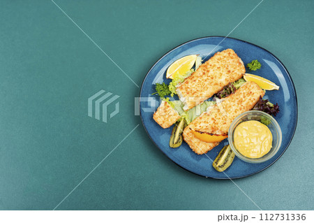 Fried pollock fillets with breadcrumbs 112731336