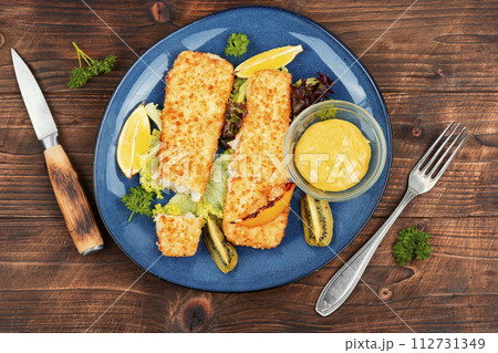 Pollock fillet baked in breadcrumbs 112731349