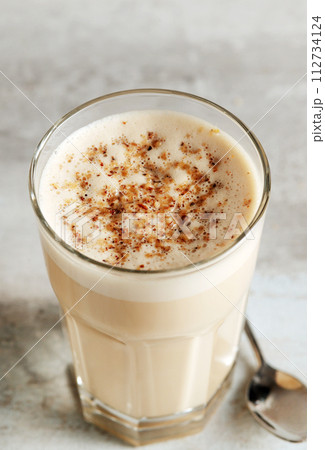 coffee with milk and grated nut in a glass close-up. Raff coffee coffee with milk and grated nut in a glass close-up. Raff coffee 112734124