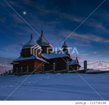 Night countryside hills, groves and farmlands in winter remote alpine mountain village. Ukraine, Voronenko. Night countryside hills, groves and farmlands in winter remote alpine mountain village. Ukraine, Voronenko. 112736196