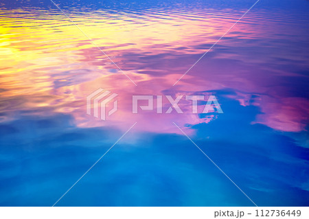 Seascape at sunset light. Calm sea water with clouds and sun reflection. Abstract nature landscape background. Gradient color 112736449