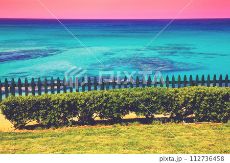 Seascape in summer evening. Wooden fence on the embankment Seascape in summer evening. Wooden fence on the embankment 112736458