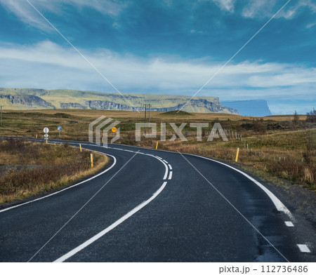 Highway road and mountain view during auto trip in Iceland. Spectacular Icelandic landscape with  scenic nature 112736486