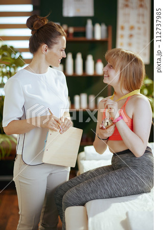 happy female medical massage therapist in massage cabinet 112737985