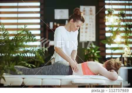 massage therapist woman in massage cabinet making massage 112737989
