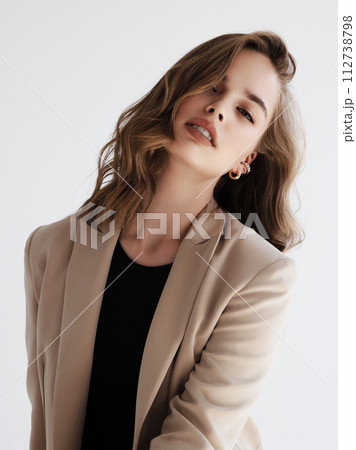 girl in a beige jacket fashion on a white 112738798