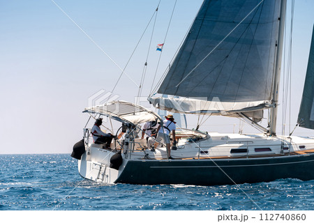 Close-up of a yacht with crew in open sea 112740860