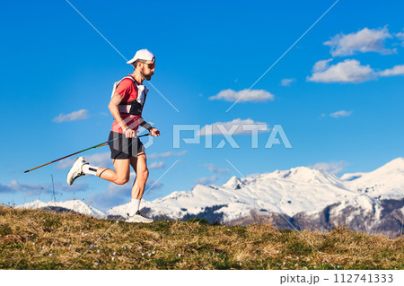 Sporty man practices nordic walking in the hills 112741333