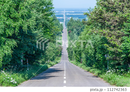 夏の北海道　人気の観光名所　快晴の天に続く道 112742363
