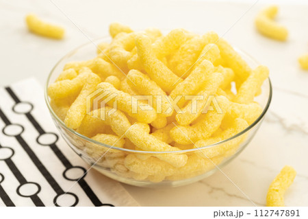 Corn sticks in bowl on table still life Corn sticks in bowl on table still life 112747891