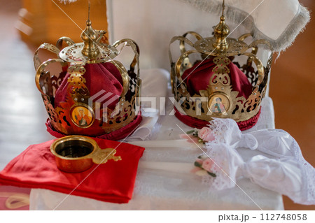 Orthodox wedding crowns and icons, essential in traditional marriage ceremonies. Representative of unity and spiritual commitment Orthodox wedding crowns and icons, essential in traditional marriage ceremonies. Representative of unity and spiritual commitment 112748058