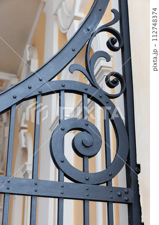 Vintage black forged gate decoration details, close-up 112748374